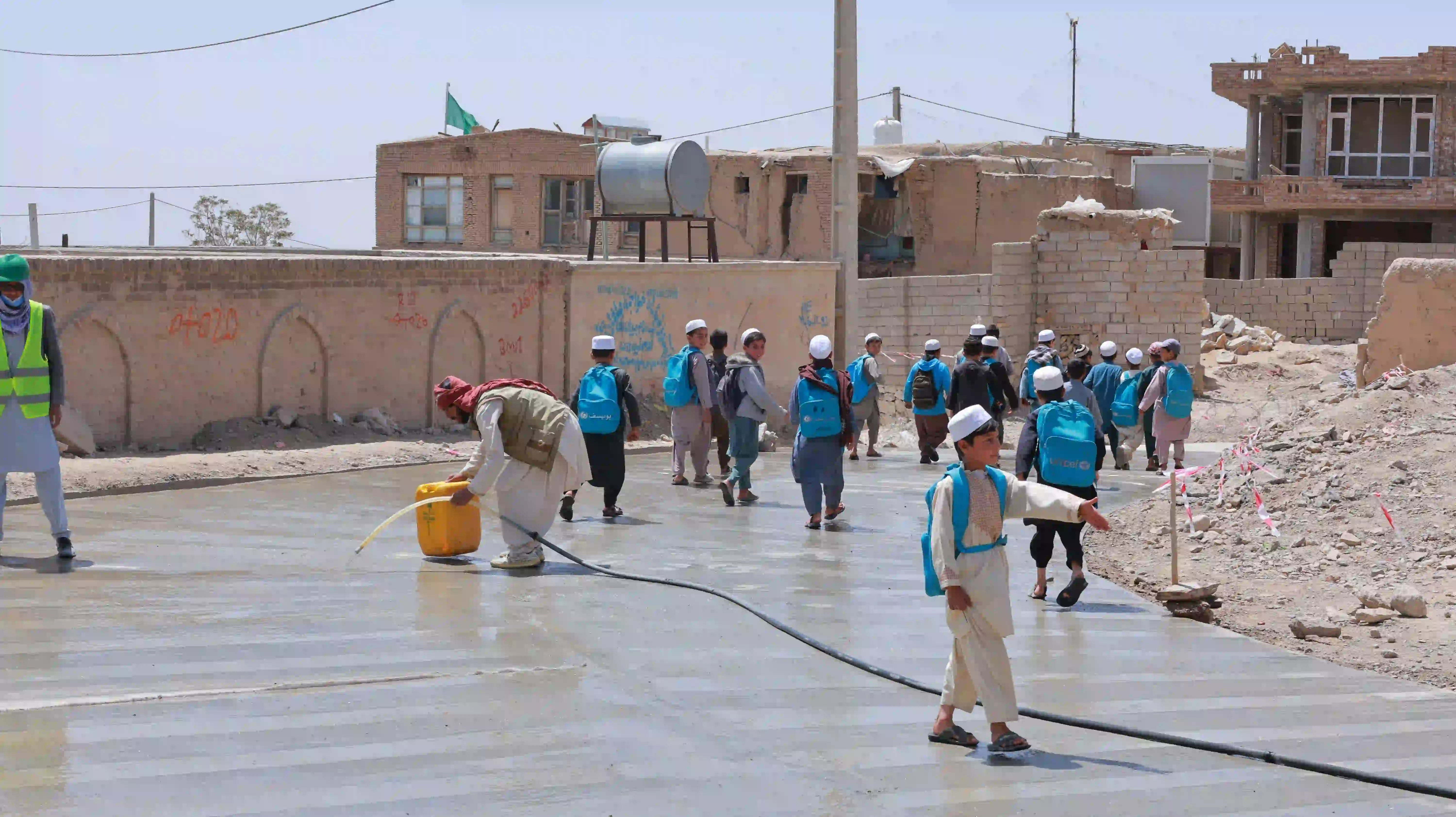 SCHOOL STUDENTS WALKING ON THE CONSTRUCTED PLUM CONCRETE SURFACE STREET (L=600M), GOZAR #6, DISTRICT #2, GHAZNI CITY