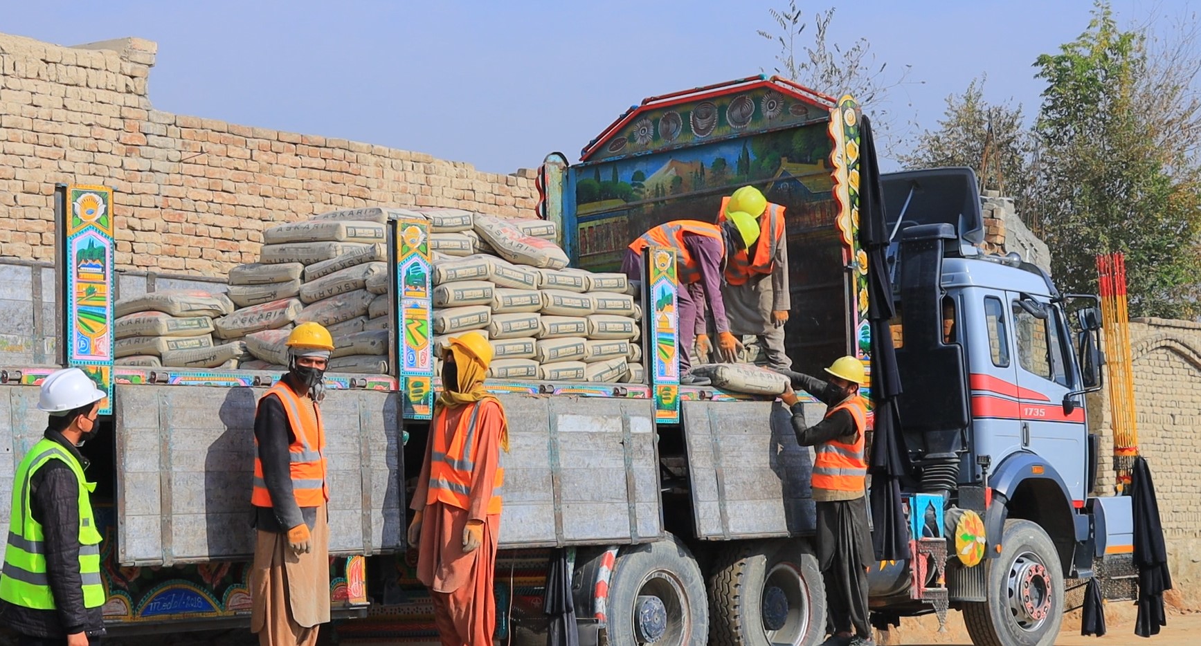 LABORERS UNLOAD CEMENT SUPPLIED BY A LOCAL PRIVATE CONTRACTOR FOR A CRLP SUBPROJECT, SUPPORTING LOCAL BUSINESSES, CREATING JOBS, AND STRENGTHENING MARKET LINKAGES IN KABUL CITY. 